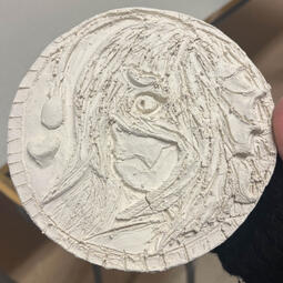 A little clay coin thing